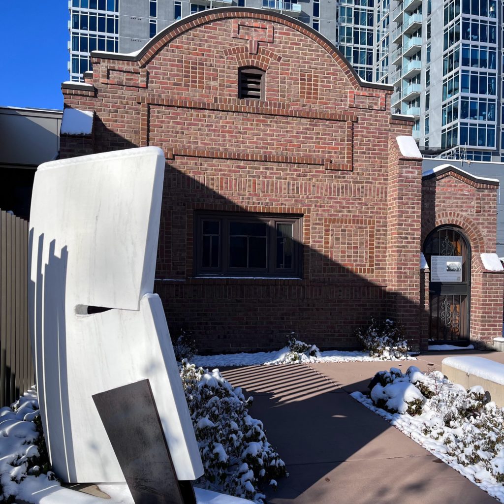 Exterior of Vance Kirkland's Studio & Art School Building with snow and white Michael Clapper sculpture