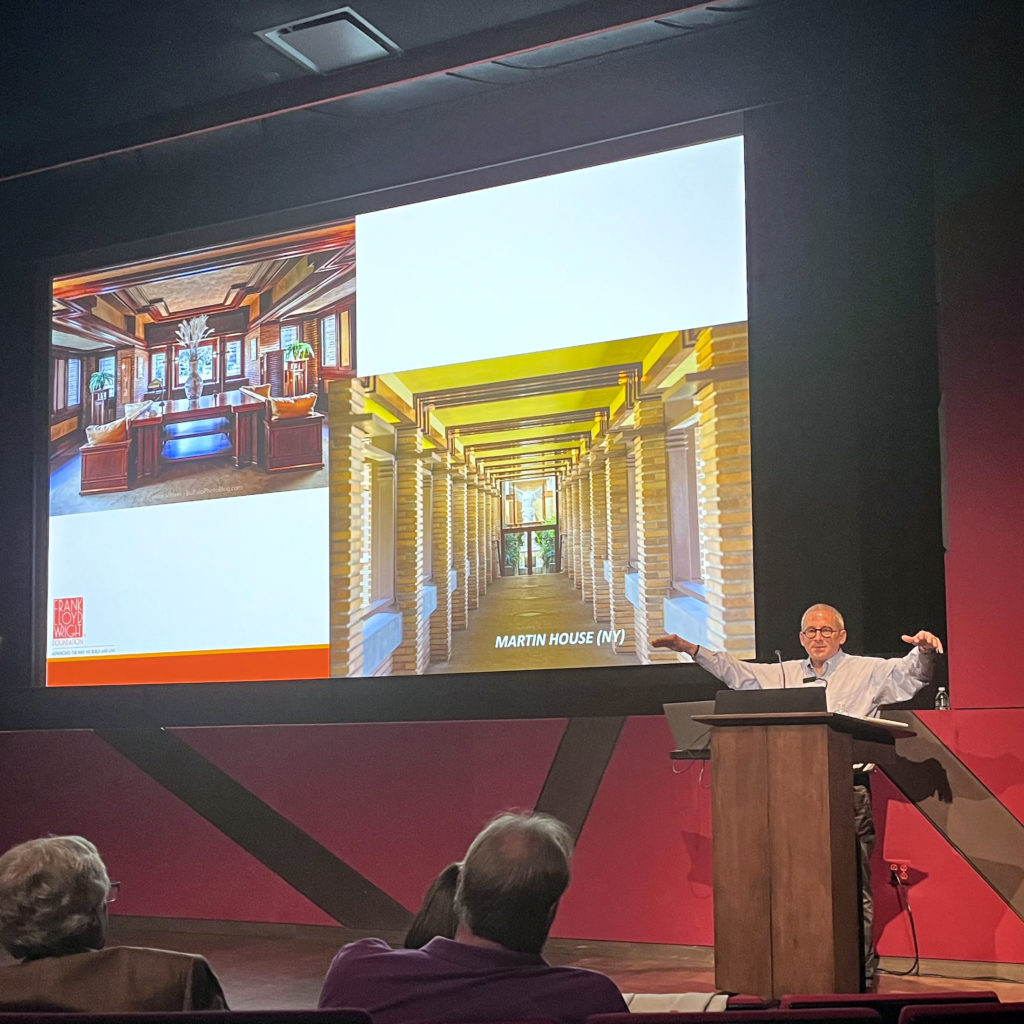 Stuart Graff at a podium with a slide projected, speaking on Frank Lloyd Wright in August 2022.